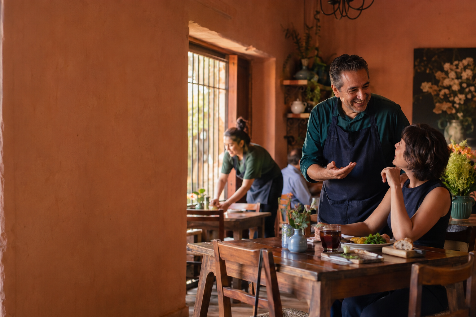 Dueño de local conversando con una clienta durante el servicio